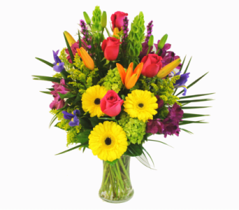 Mixed bouquet of bright flowers in a clear glass vase