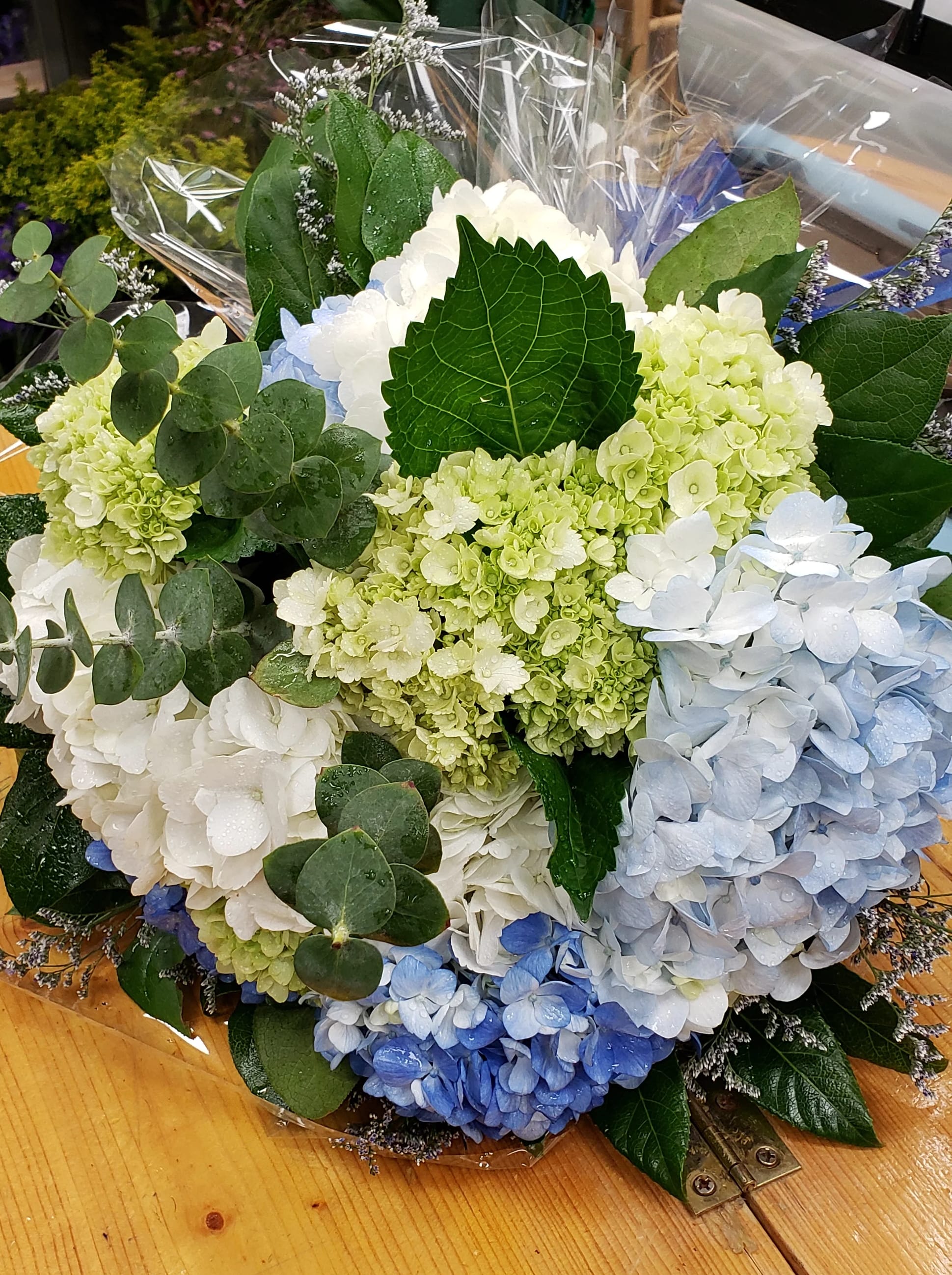 Bouquet of blue, white, and green hydrangeas with eucalyptus