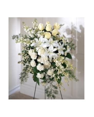 White and pale yellow floral standing spray on an easel