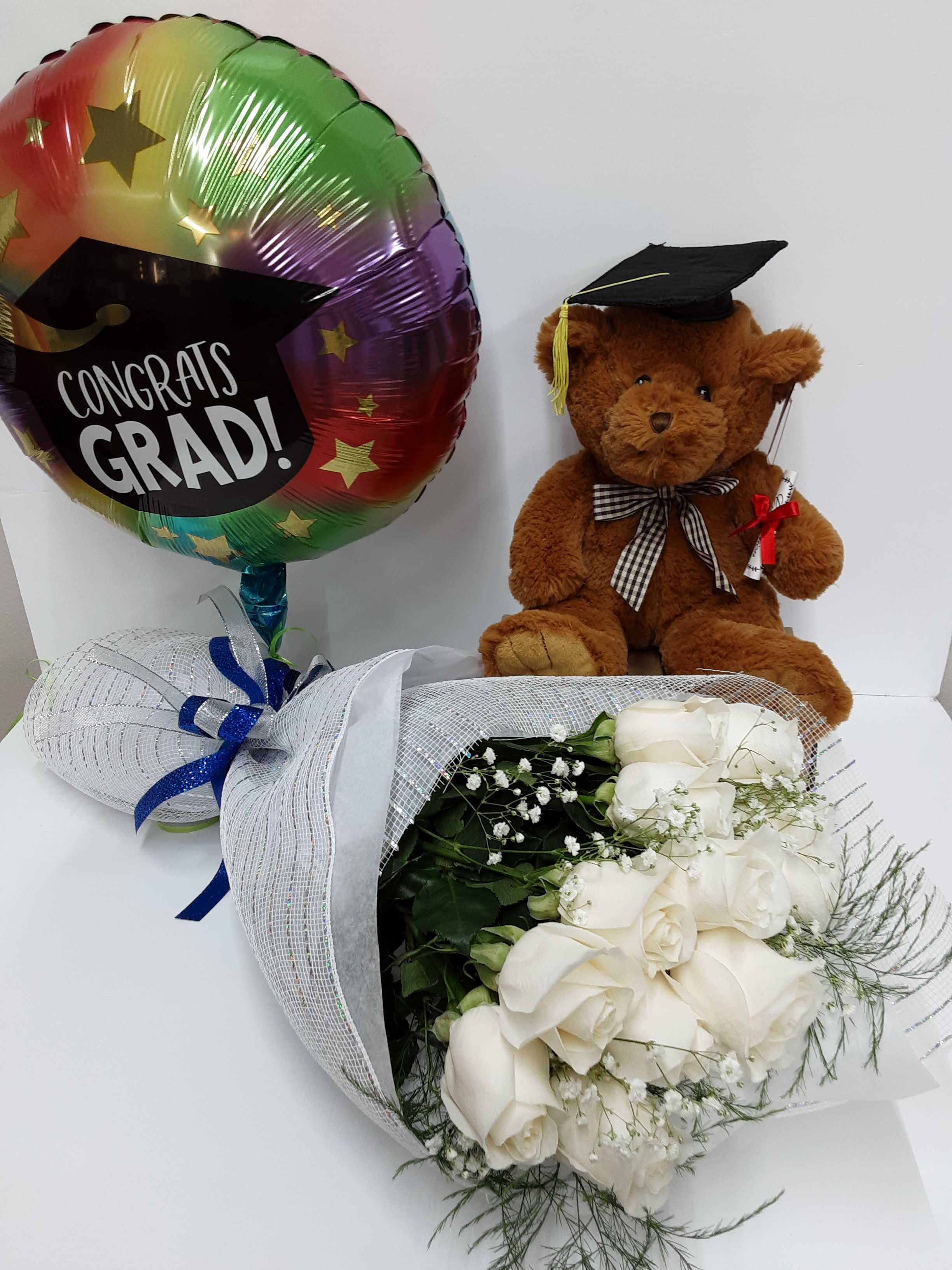 White rose bouquet with a graduation balloon and teddy bear