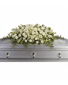 White floral casket spray on a silver casket