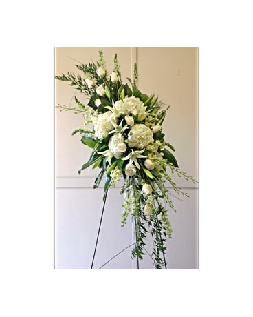 Tall white floral standing spray on an easel