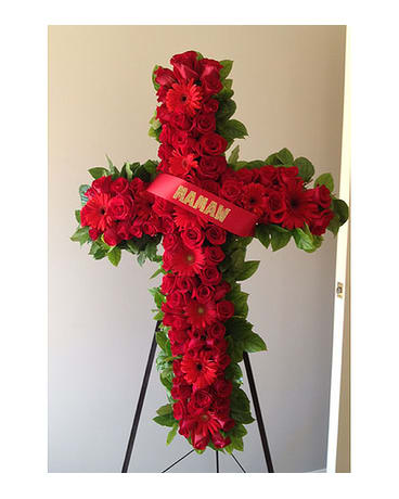 Red floral cross on an easel with a ribbon reading MAMAN