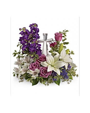 Purple and white floral arrangement with roses and lilies tied with a silver ribbon