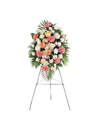 Standing floral spray with pink, white, and peach flowers on an easel