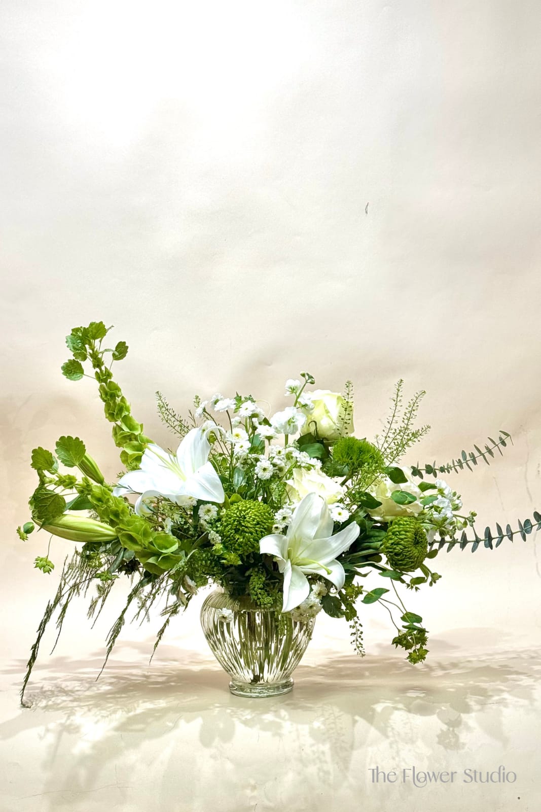 Golden Touch - A fresh and airy arrangement in soft whites and vibrant greens, accented with warm golden tones. Designed with a natural, garden-inspired feel, it brings a sense of lightness and effortless beauty—perfect for celebrating Mother’s Day.