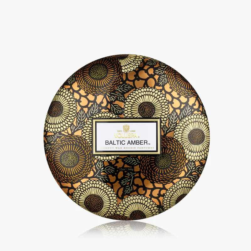 Round floral-patterned candle tin labeled Baltic Amber