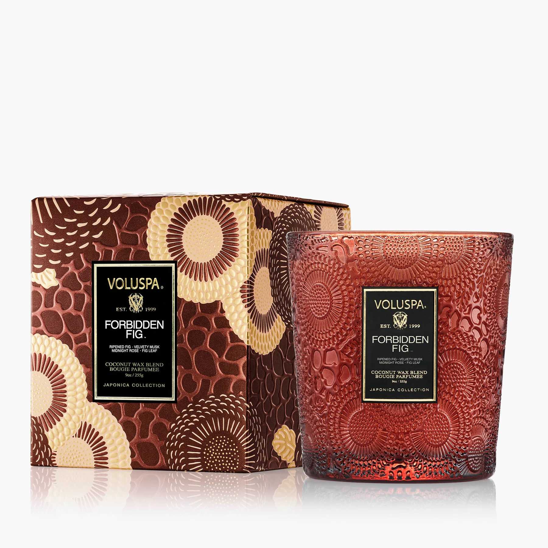 Decorative red glass candle in a patterned box