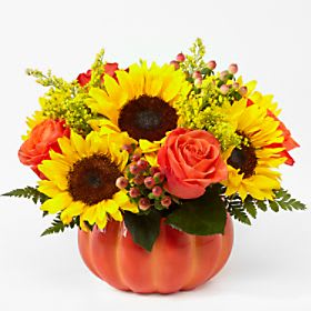 Sunflowers and orange roses - This ceramic pumpkin is full of vibrant blooms and accents of lush greens.