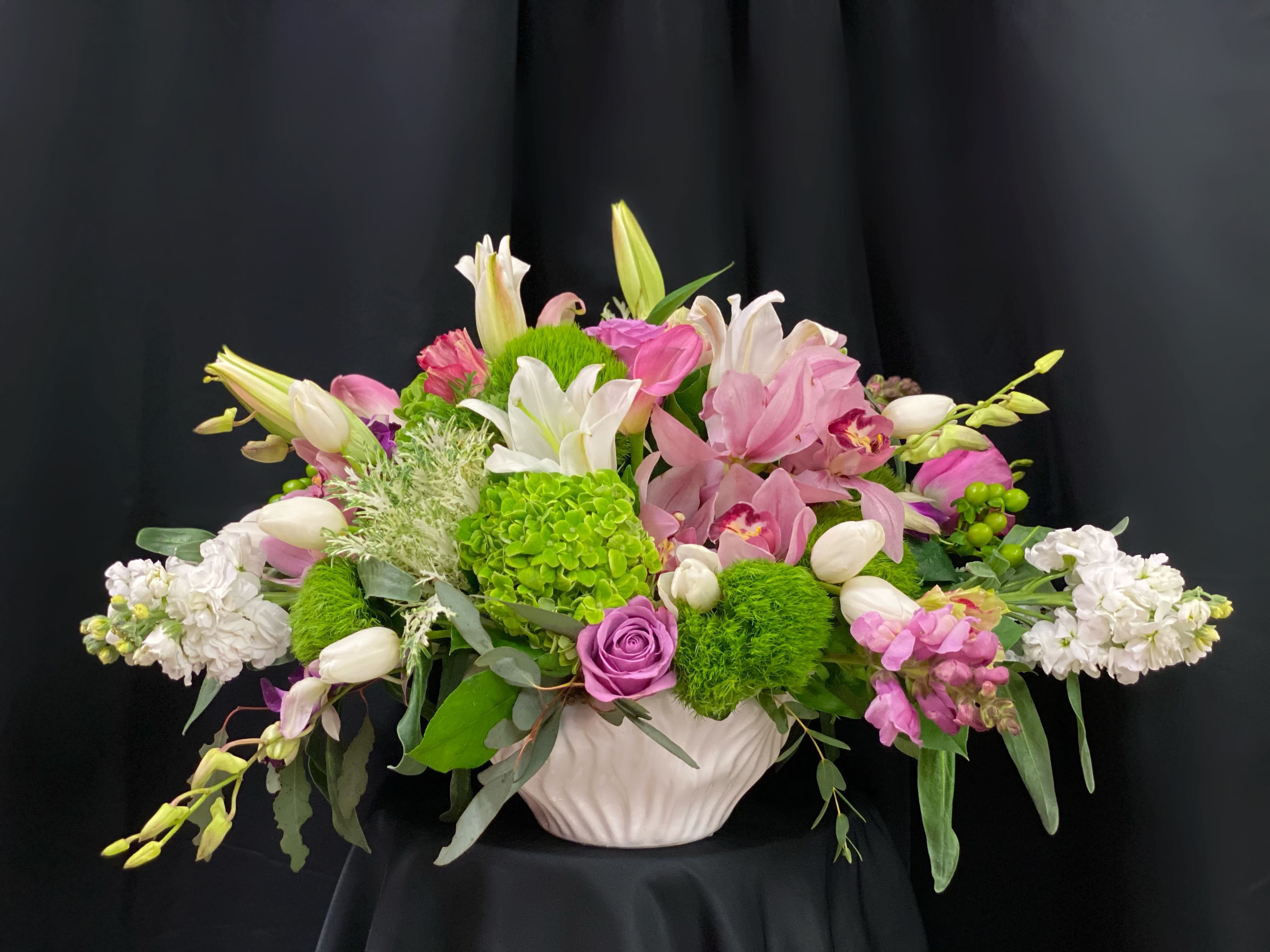 Pink and white floral arrangement in a white vase