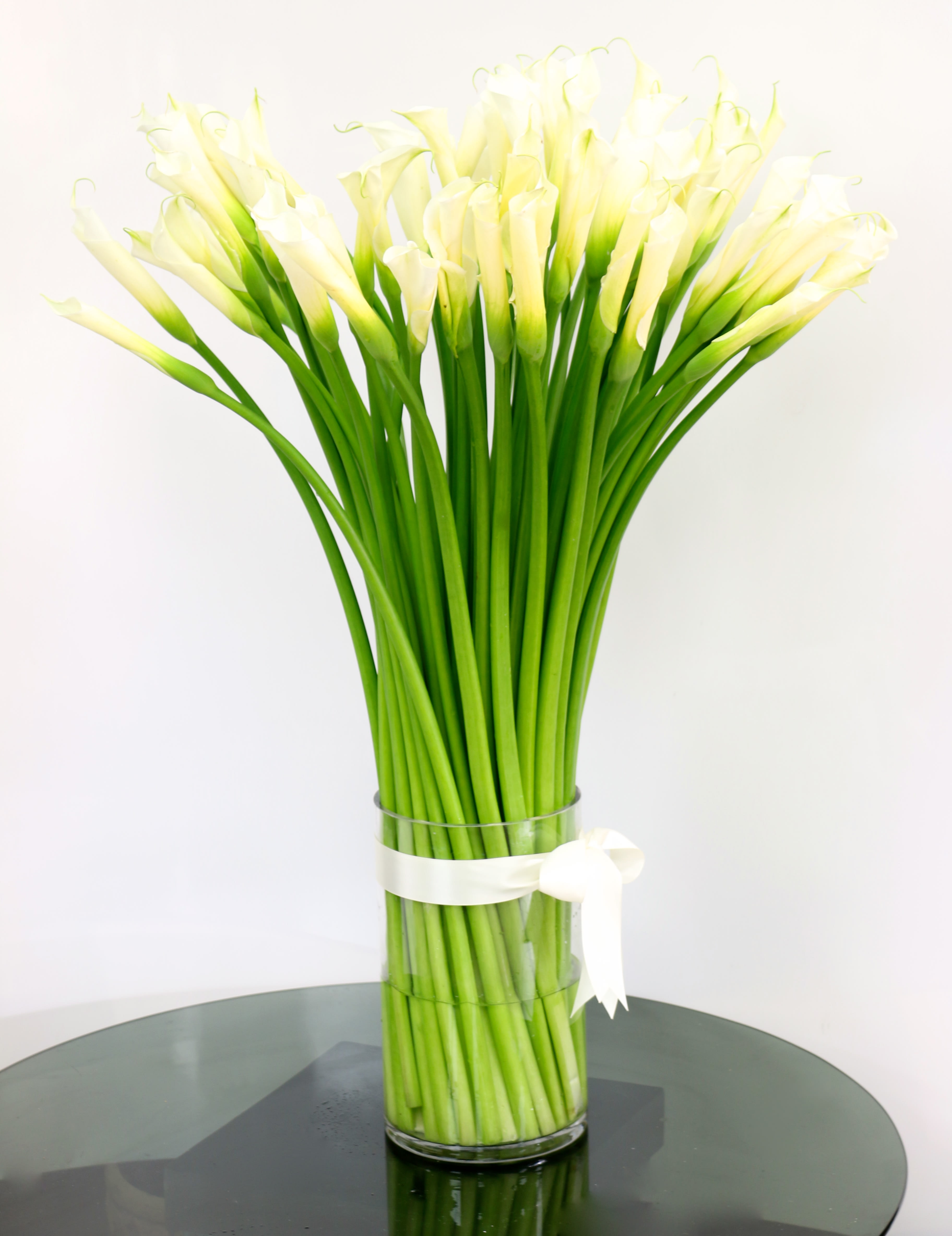 Classy Callas  (BR) - Classy Calla Lilies in a glass cylinder vase Approx. 36" Tall   