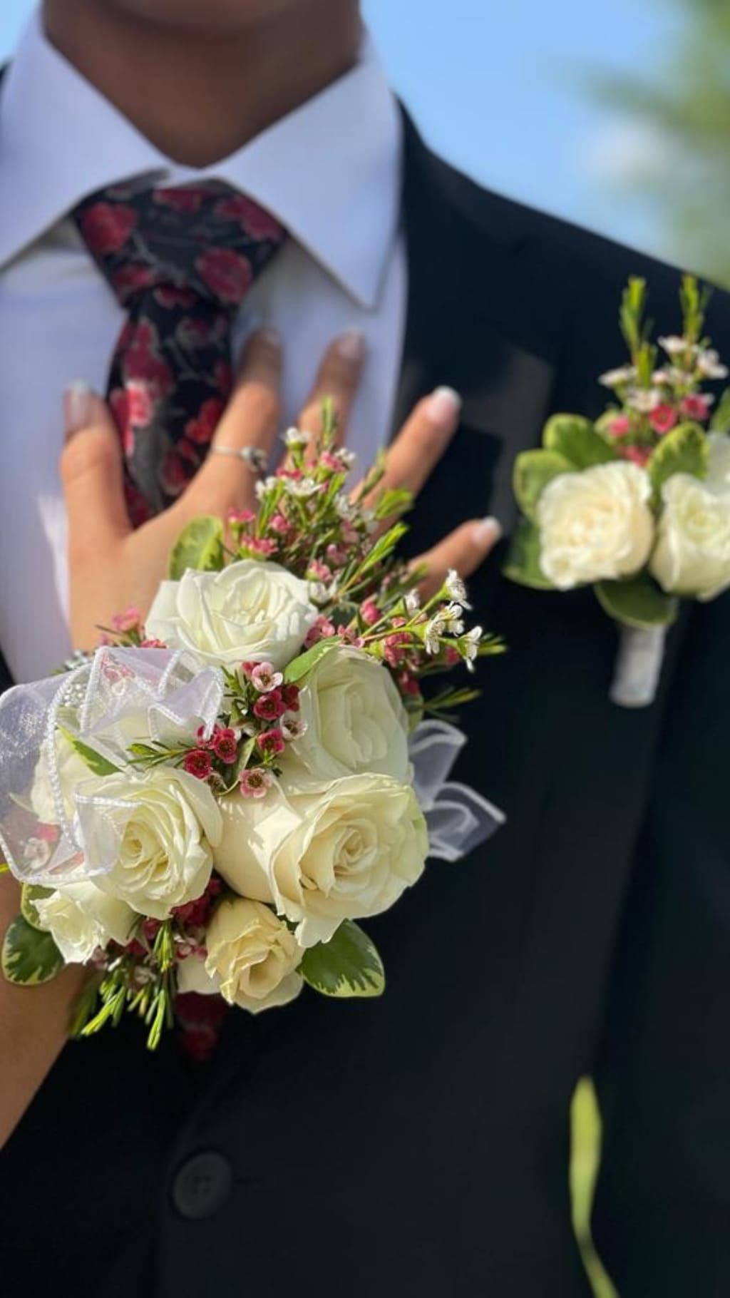 White rose bouquet and matching boutonniere on a suit jacket