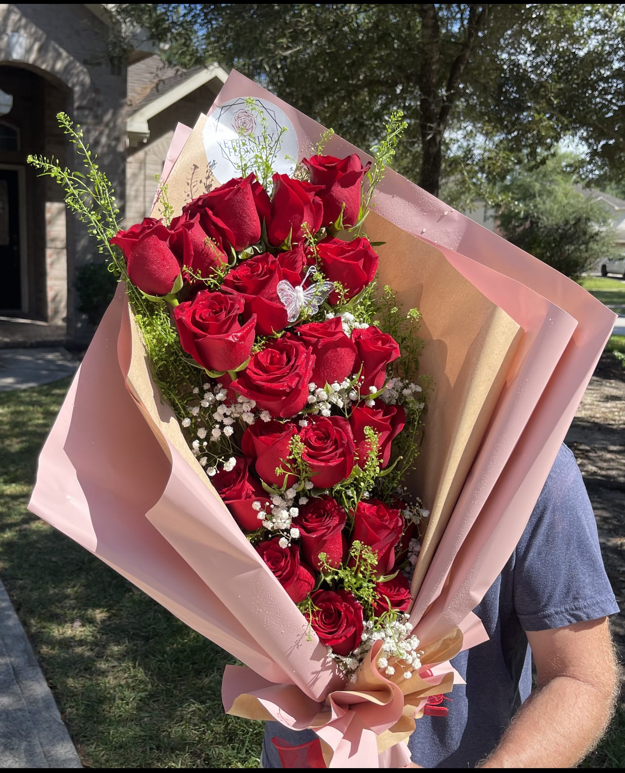 Bouquet of red roses wrapped in pink paper