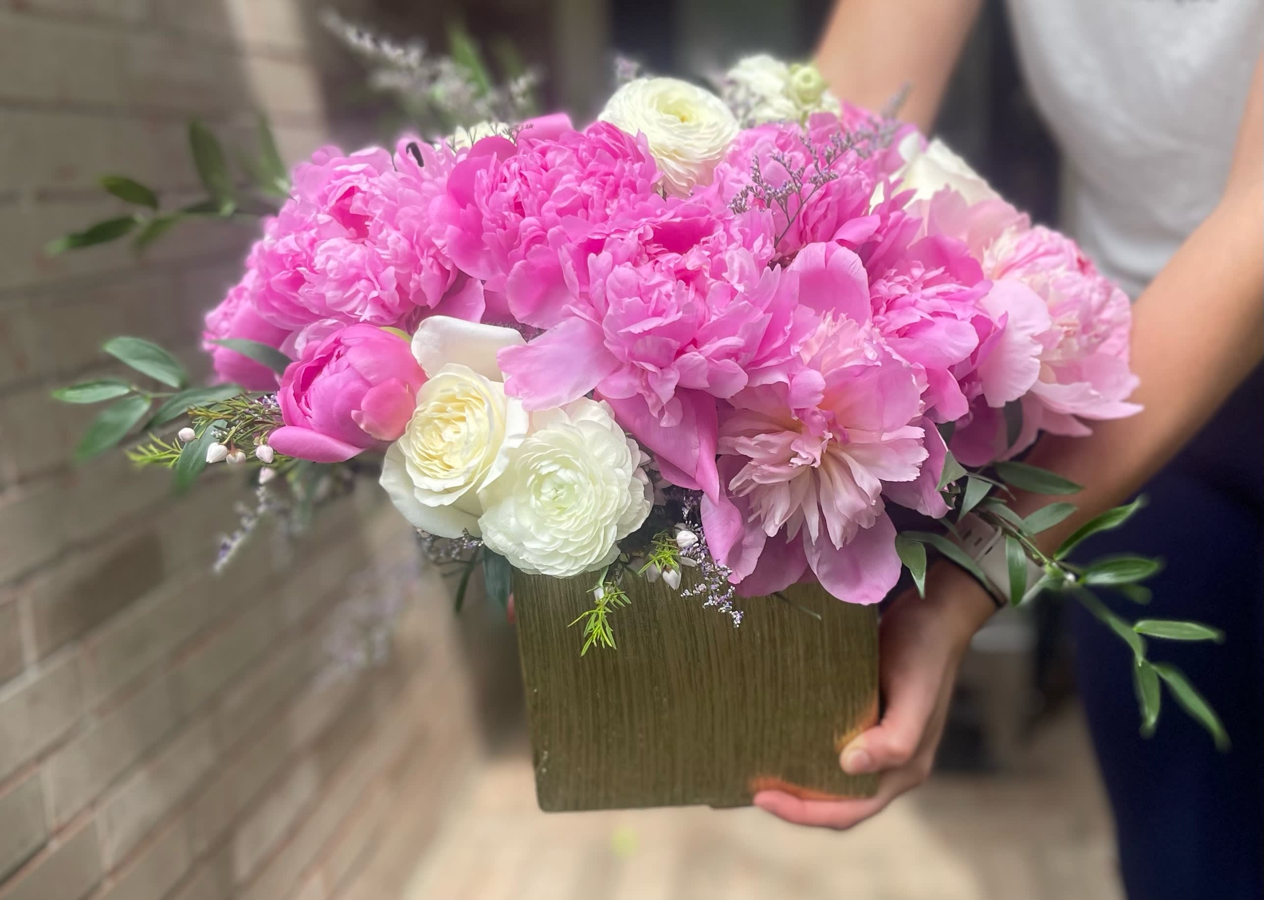 Pink and white bouquet in a square vase