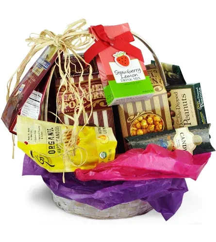 Basket of assorted candy and snack boxes with colorful tissue paper