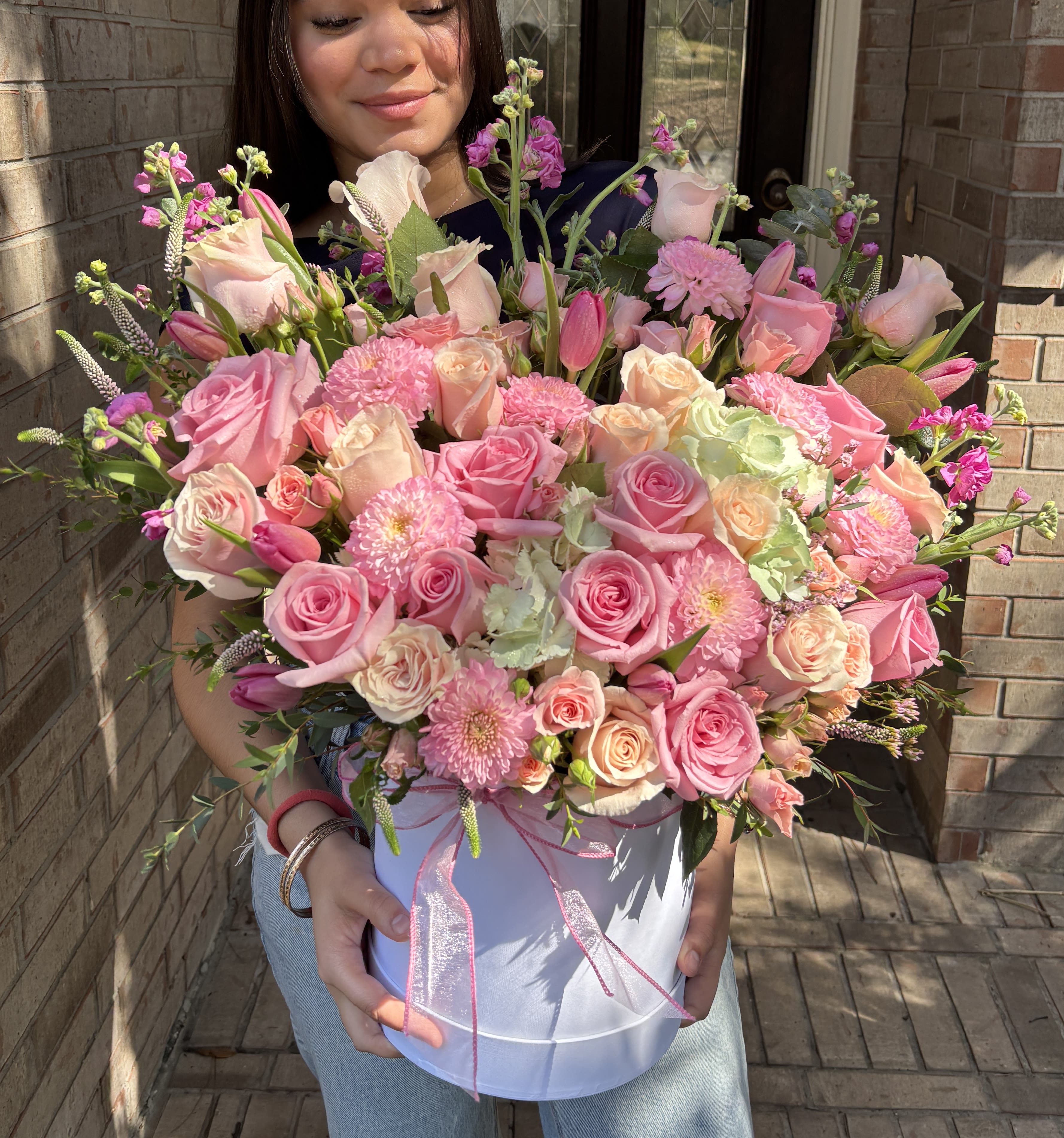 Large pink bouquet in a white hatbox with ribbon