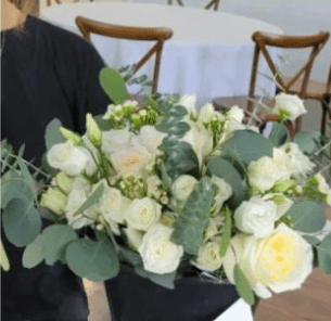 White rose bouquet with eucalyptus in a black wrap