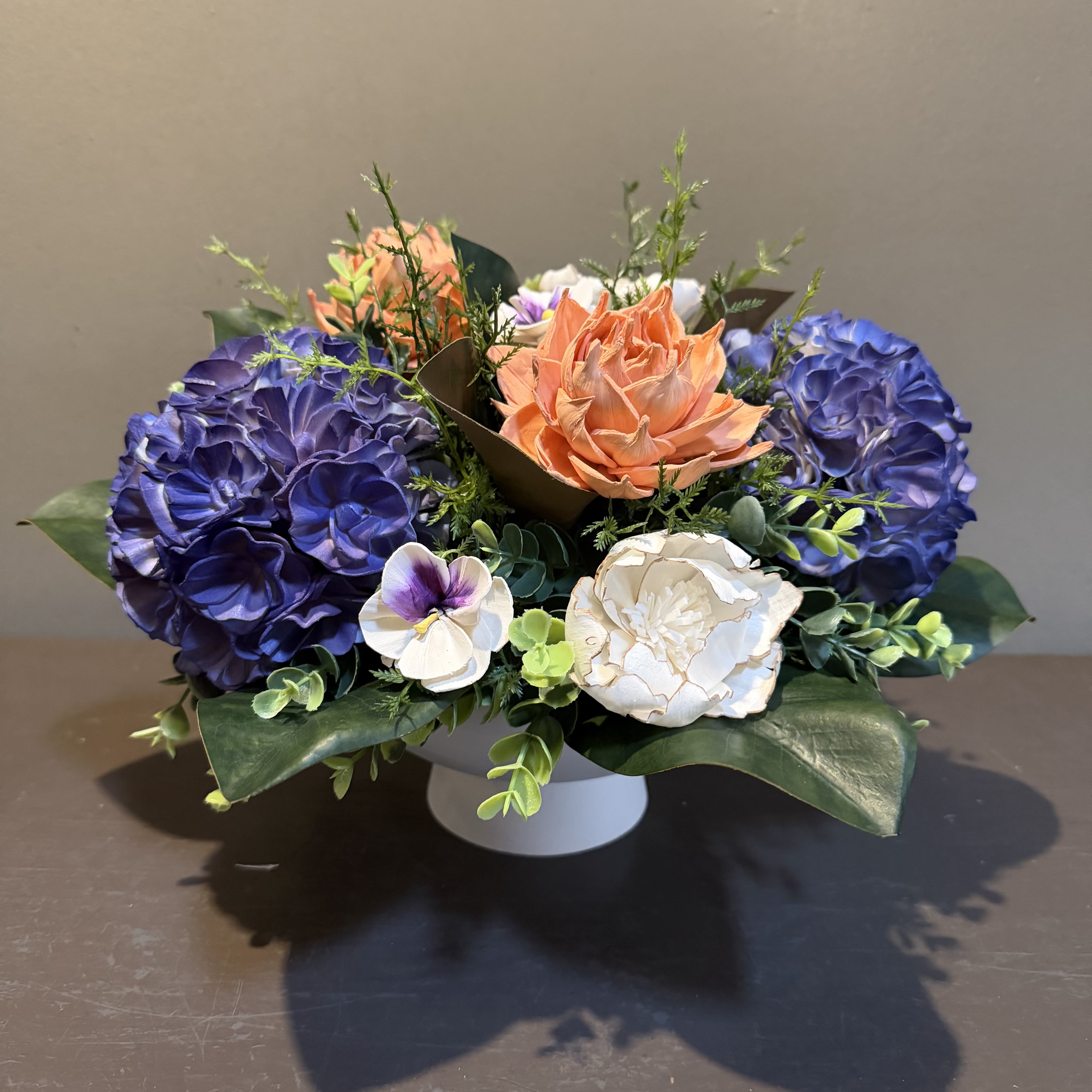 Sola Wooden Flower Centerpiece - Heavenly Hydrangea - Hand-dyed and hand-crafted in Minneapolis, these flowers made of balsa wood are a wonderful everlasting floral arrangement - great for those with allergies! Can be used as a natural essential oil diffuser too! Approx. Dimensions: 14"Wx10"T in a white container. 