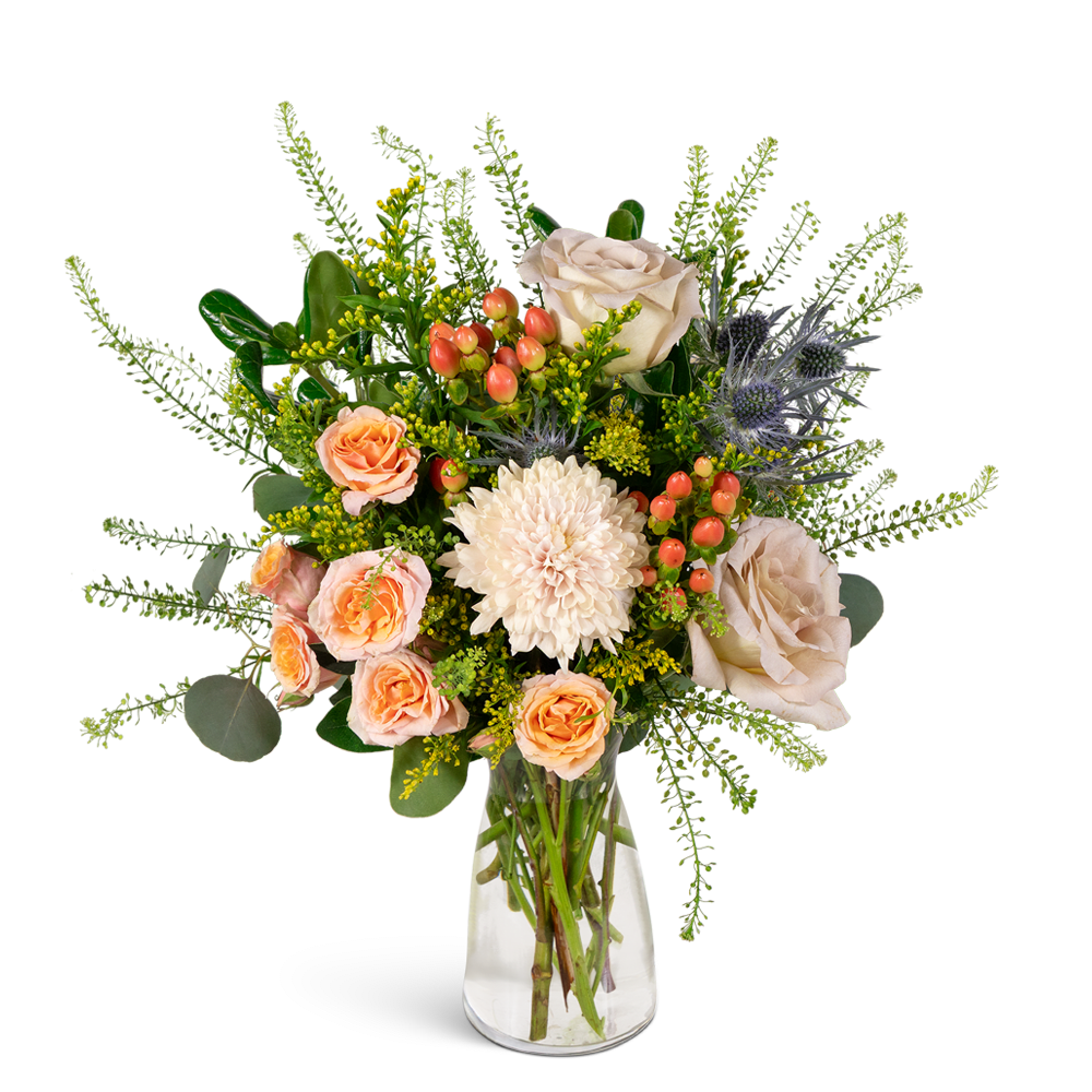 Peach and cream bouquet with roses and a white chrysanthemum in a clear glass vase