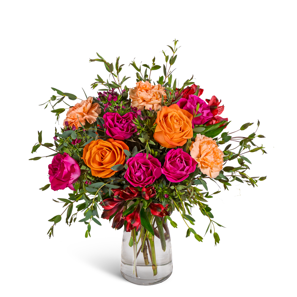 Bouquet of orange and magenta roses with peach carnations in a clear glass vase