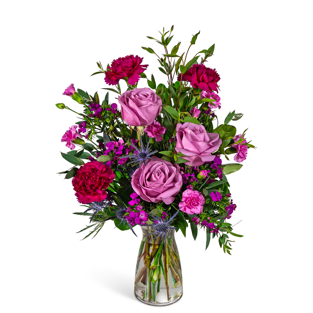 Pink and magenta mixed bouquet in a clear glass vase