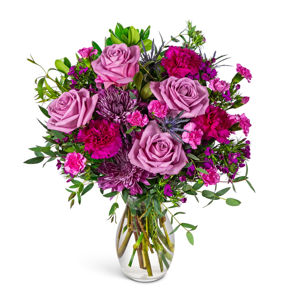 Pink and purple rose bouquet in a clear glass vase
