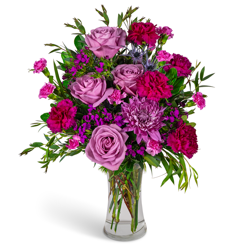 Pink roses and magenta carnations in a clear glass vase