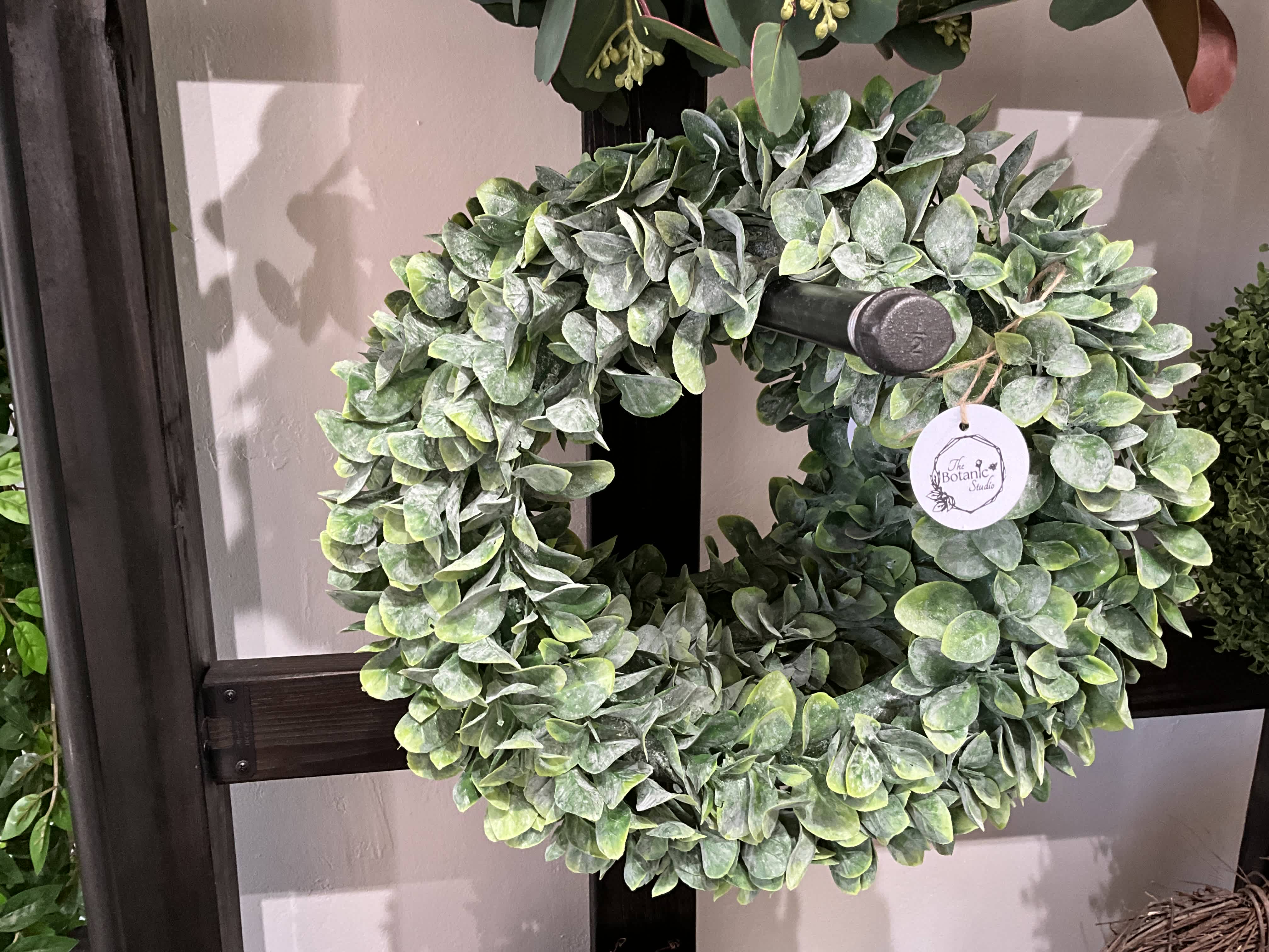 Round wreath of dense green foliage on a display stand