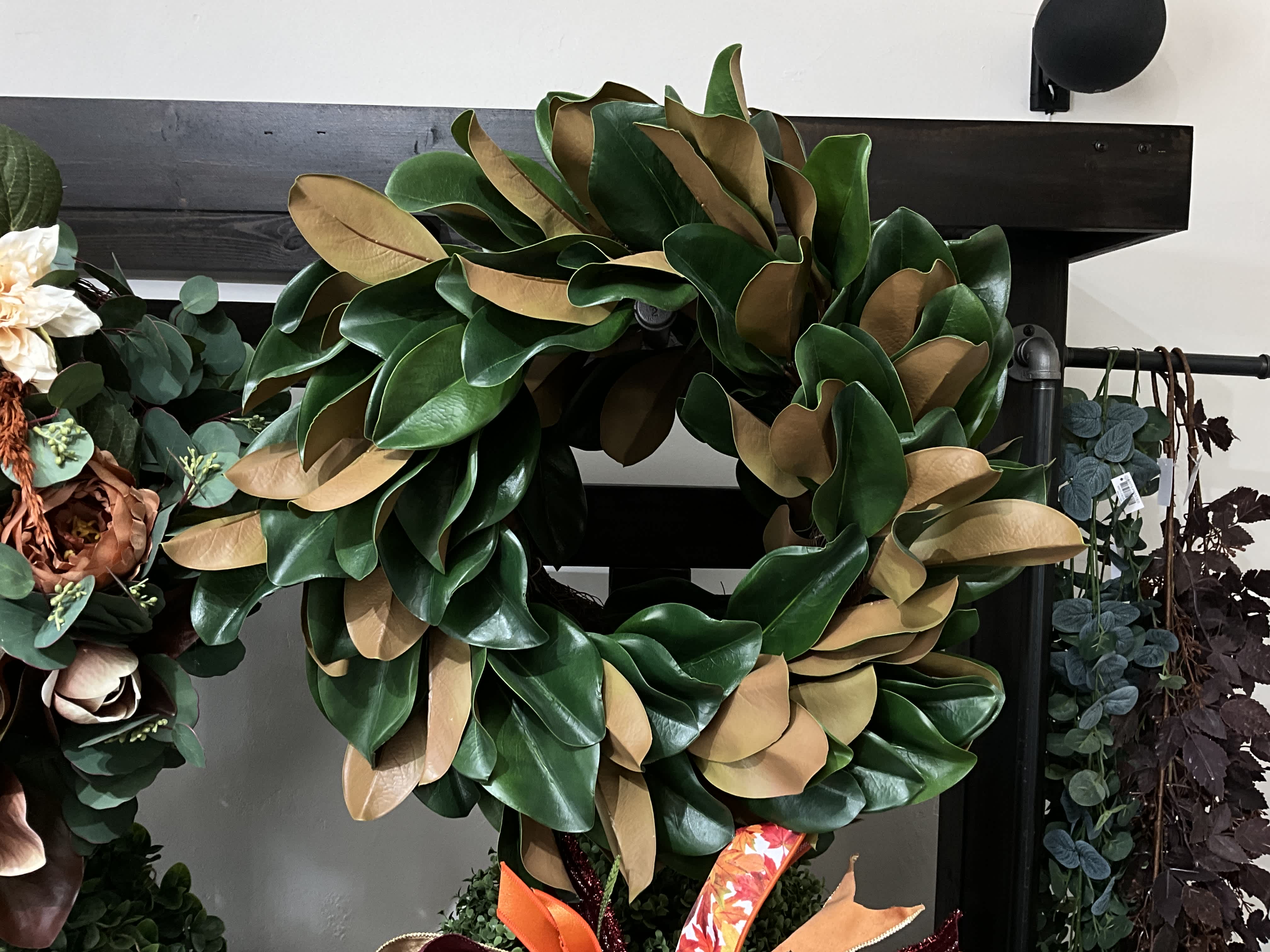 Large green and tan wreath made of magnolia leaves