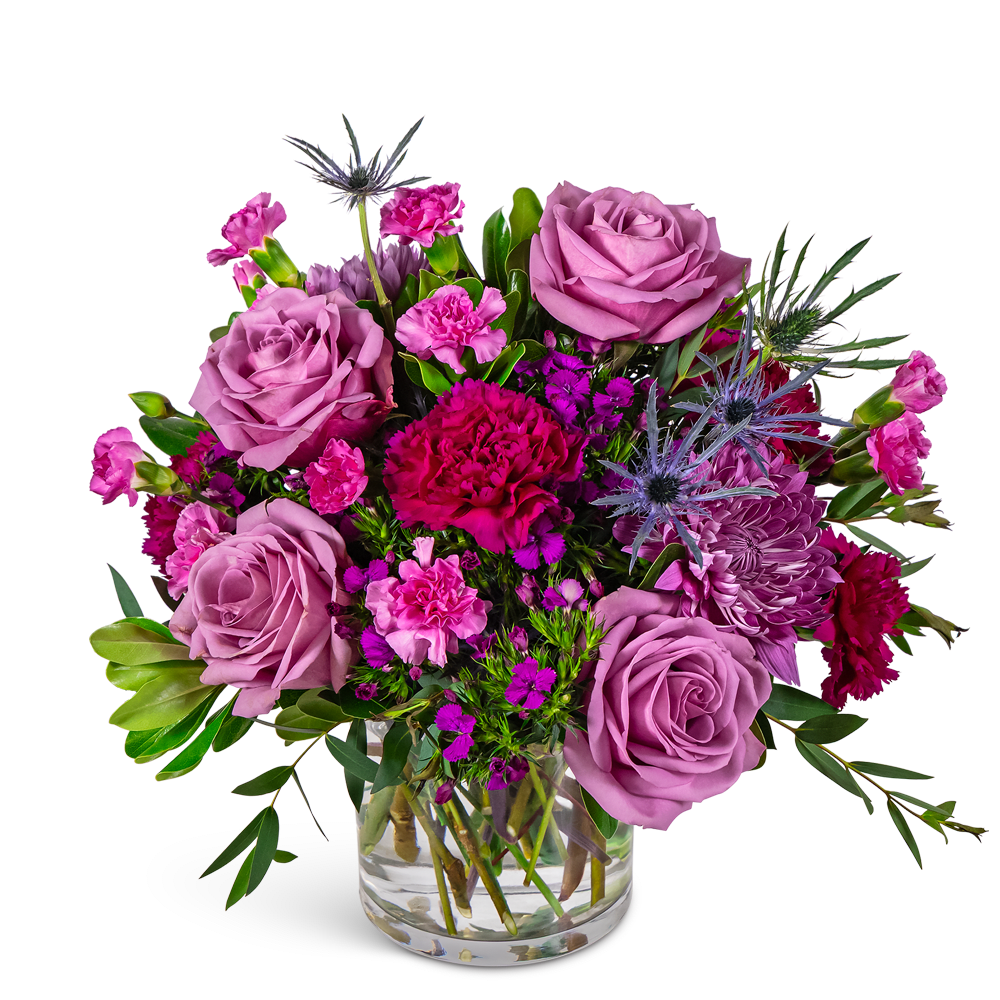 Lavender roses and pink mixed flowers in a clear glass vase