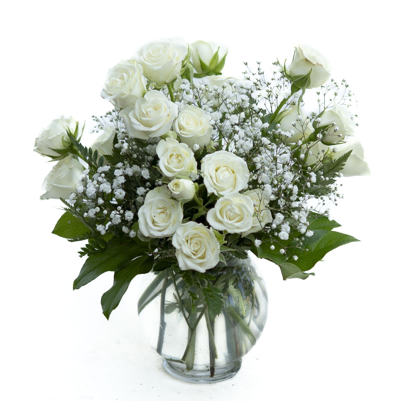 White roses and baby's breath in a clear glass vase