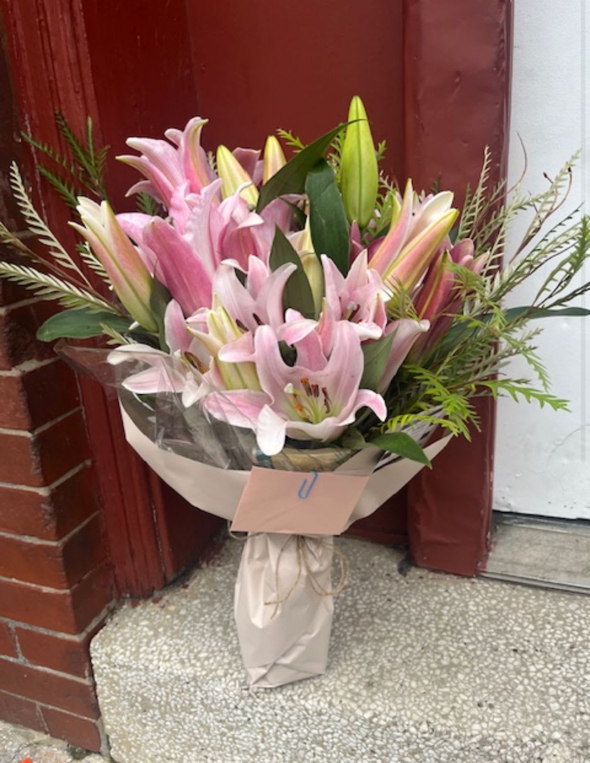 Bouquet of pink lilies wrapped in paper