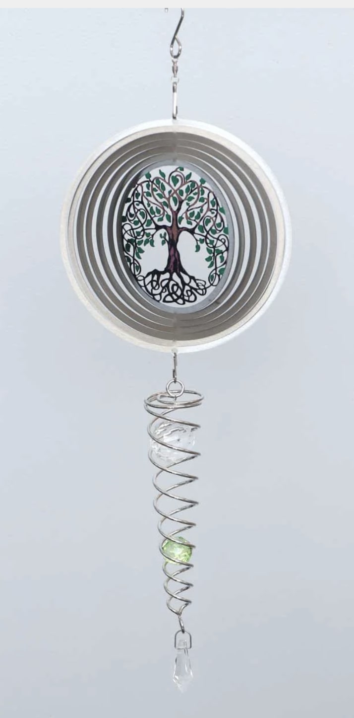 Hanging metal wind spinner with a tree design and crystal pendants