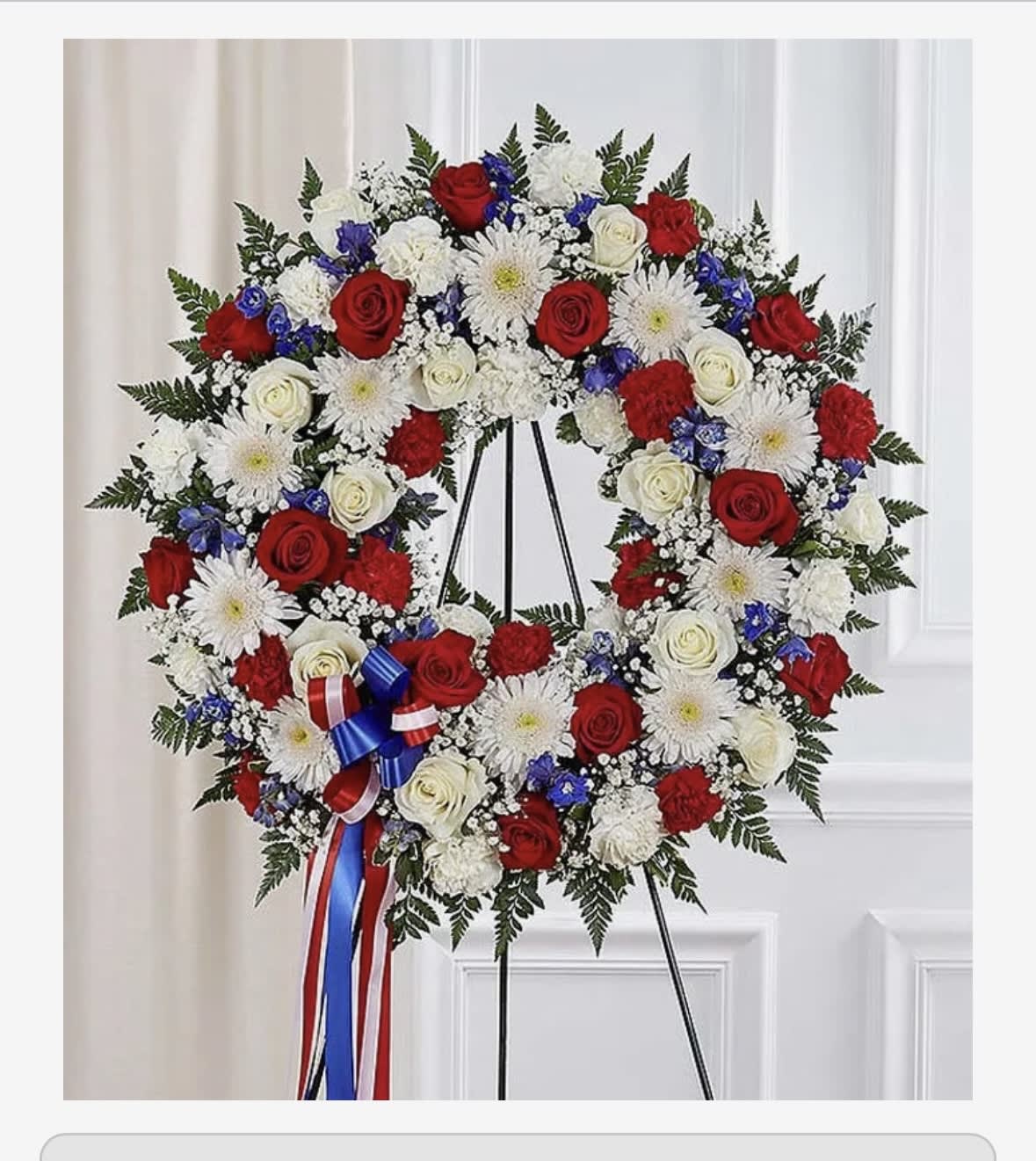 Patriotic Wreath - A perfect way to honor their beliefs and actions, this red, white, and blue wreath is a tribute to those who loved their country. 