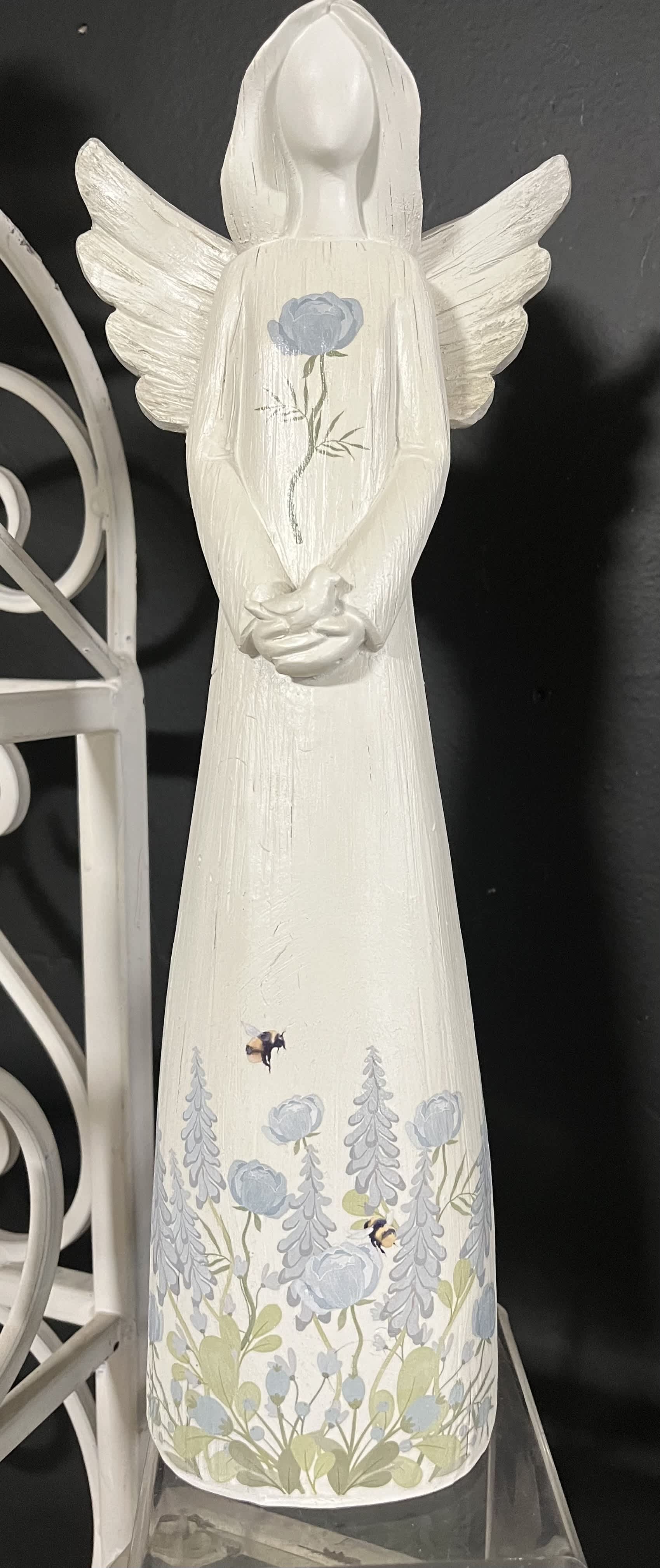 White angel figurine with blue floral painting and wings