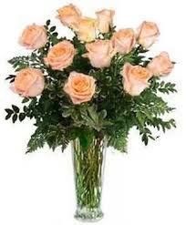 Peach roses arranged in a clear glass vase