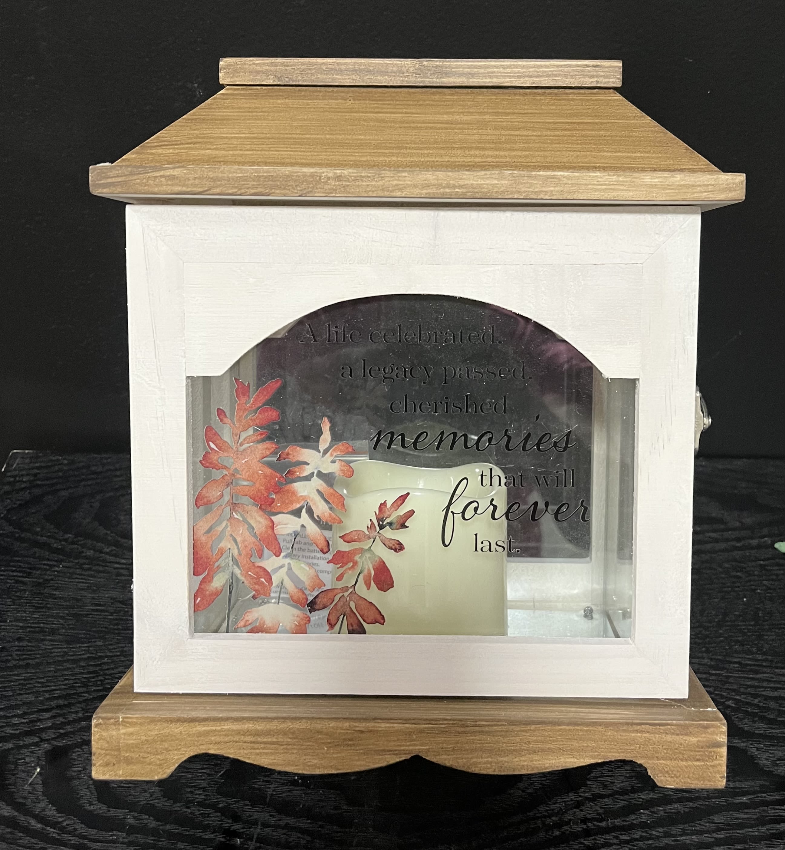 Wooden memorial lantern with a candle and autumn leaf design