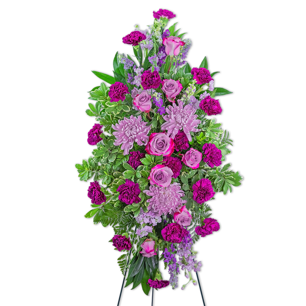 Tall standing floral spray with pink roses, lavender blooms, and magenta carnations