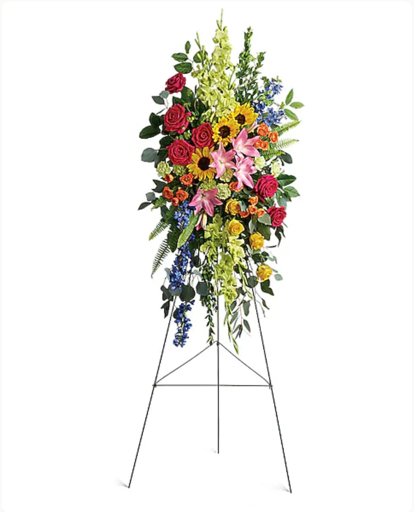 Tall standing floral spray with roses, lilies, sunflowers, and blue accents on an easel