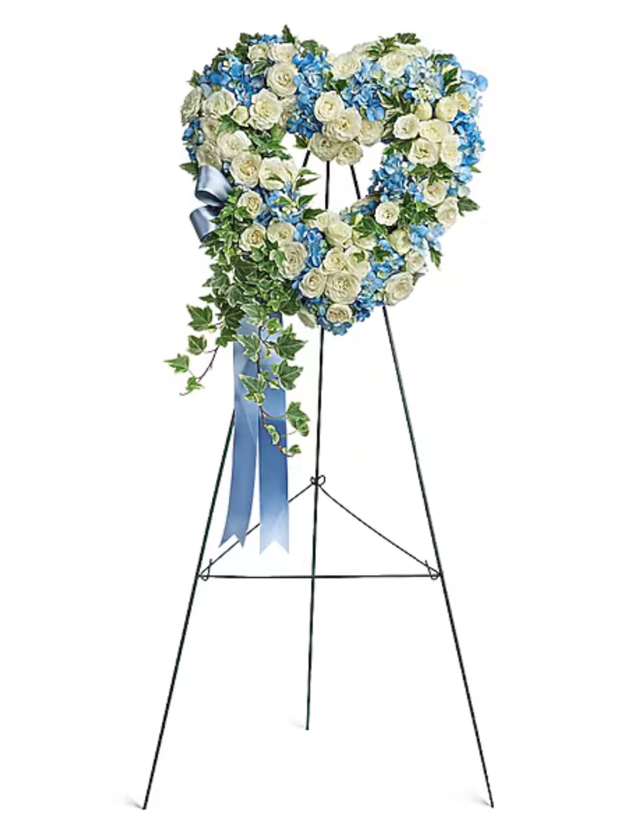 Heart-shaped floral wreath on a stand with blue and white flowers and a ribbon