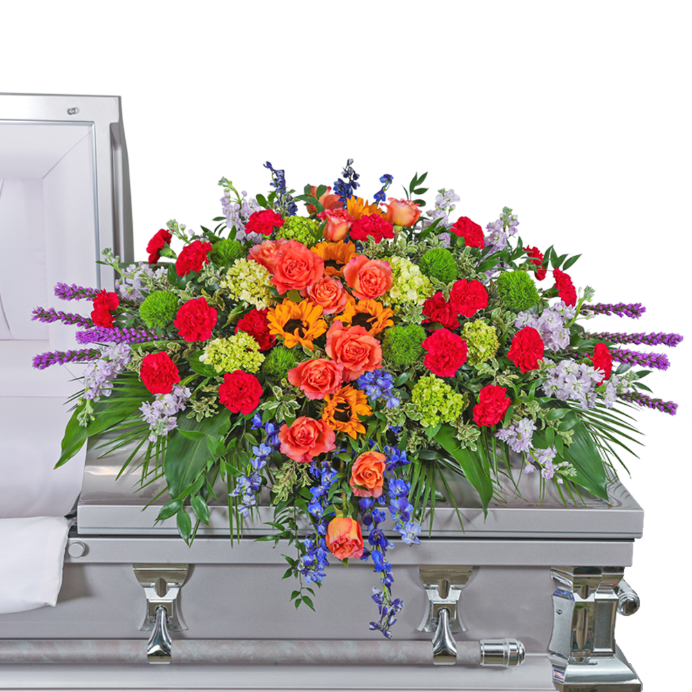 Treasured Memories Casket Spray - Sympathy flowers are a meaningful way to celebrate the life of the deceased, and forever treasure the memories you made together. Our Treasured Memories Casket Spray features Free Spirit roses, sunflowers, bright pink carnations, liatris, stock, green hydrangea, solidago, curly willow, and premium foliage. Funeral flowers bring healing in many ways, they serve as a memorial to honor the one that we lost, all while providing comfort to the friends and family left behind.