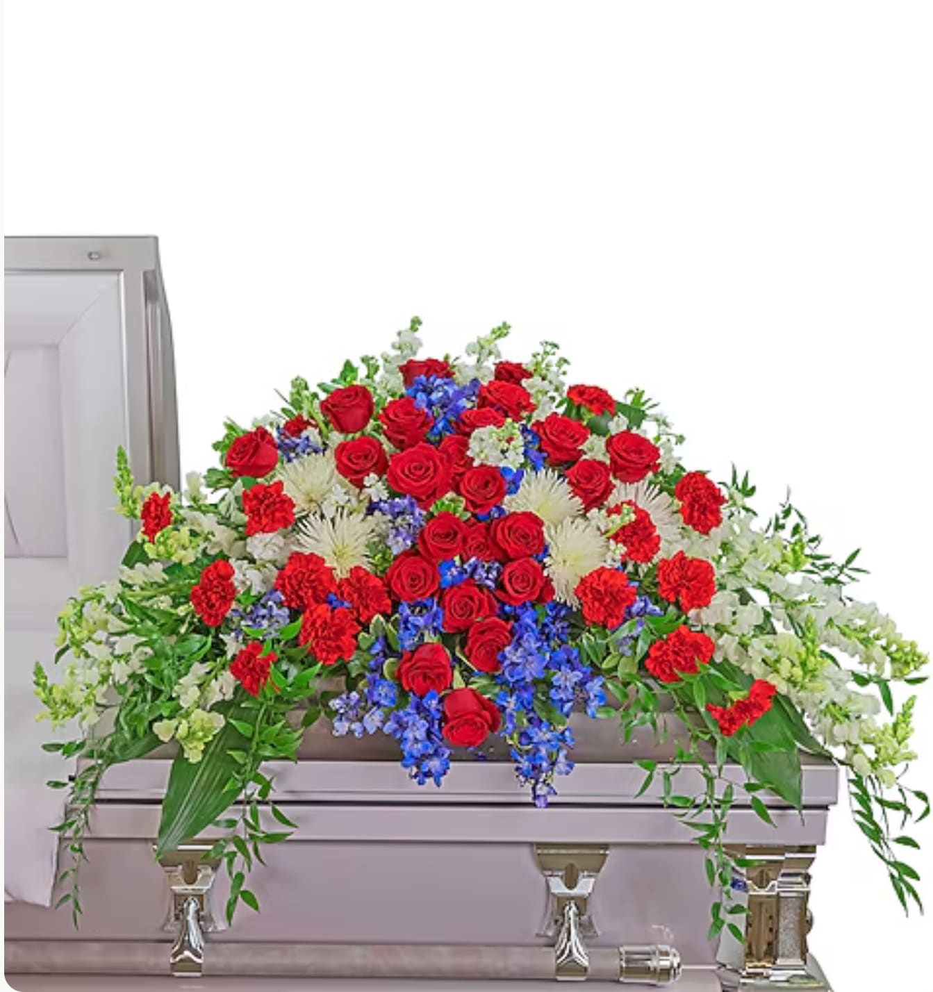 Red roses, blue flowers, and white blooms arranged on a casket