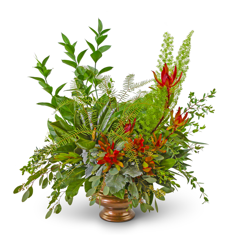 Tropical floral arrangement with red-orange blooms in a bronze vase