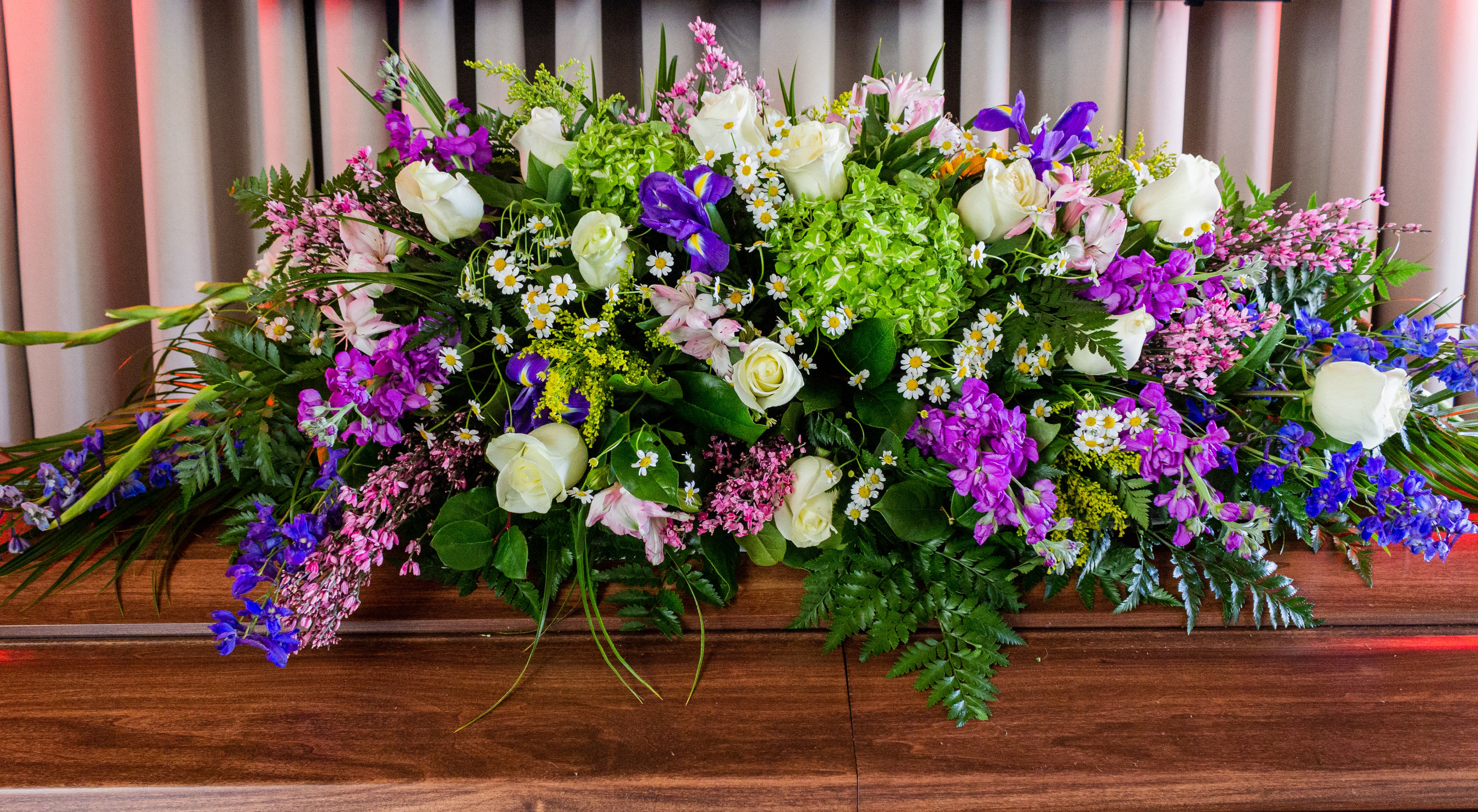 FUNERAL CASKET SPRAY - Sweet Dreams 117 - This is a stunning option for a funeral service or church. This casket can be designed as a half casket or a full casket for either an open casket or a closed casket service. This soft mix of purples, greens and whites of roses, hydrangeas, stock and alstromeria is will look beautiful at any service or memorial.  **This is a piece for a funeral or memorial service. Please place the order at least 2 days prior to the service to guarantee a certain arrangement. Anything sooner and we cannot guarantee it will match the picture. These pieces can be customized to the color of your choice. The flowers may vary depending on availability of the flowers, special requests and quality of the flowers we have in stock. If you have a special request please add it to our special instructions when placing your order. If you have any questions please don’t hesitate to call. 714 289 1123**