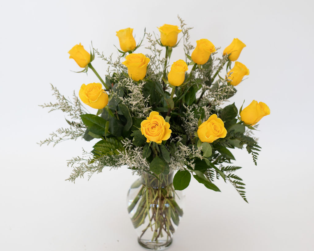 Yellow roses arranged in a clear glass vase