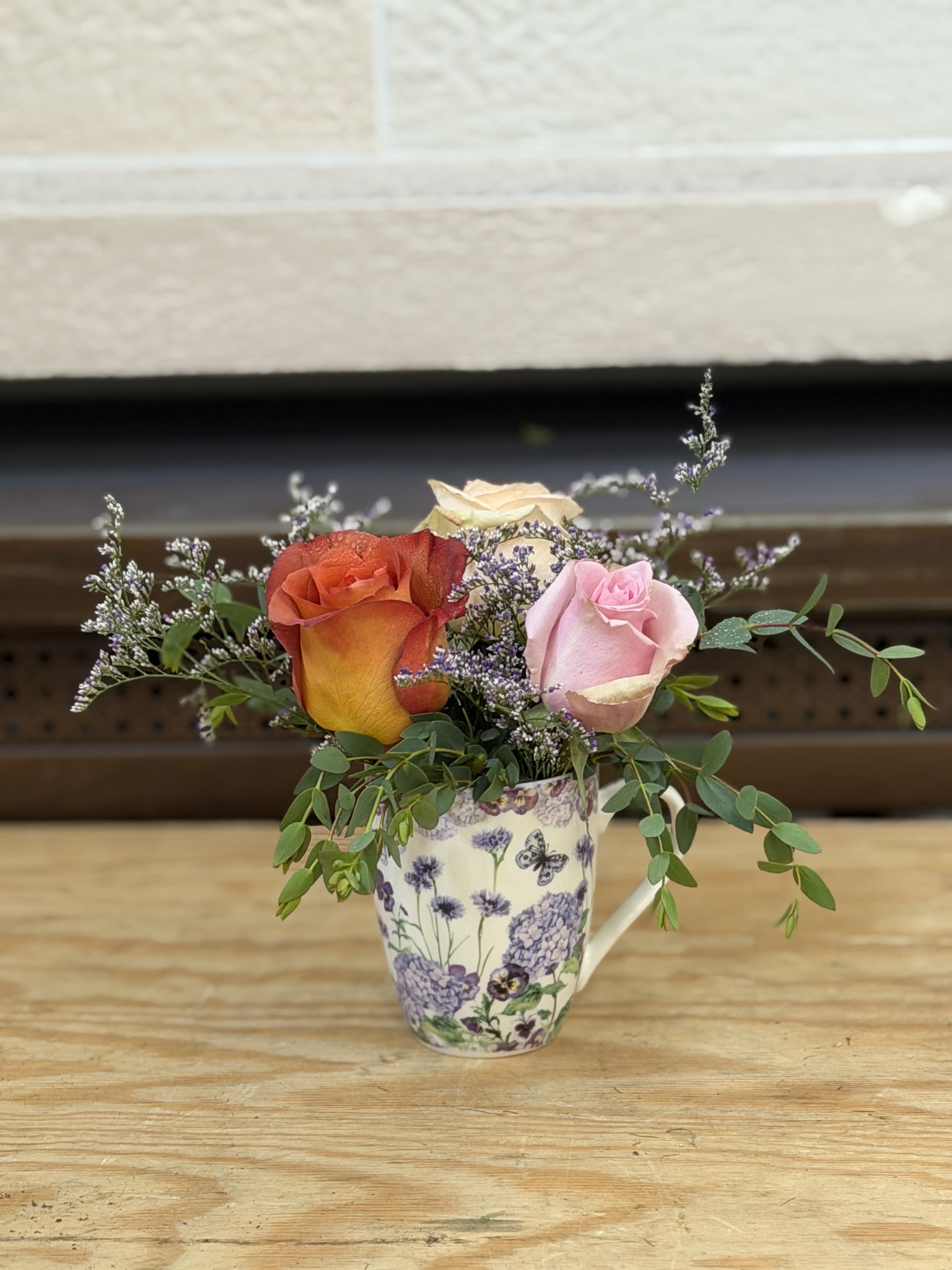Mug of Roses  - A mug filled with 3 multicolor roses. 