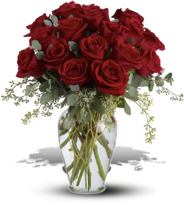 Red roses arranged in a clear glass vase