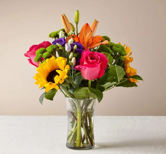 Best Day Bouquet - Make this day their best day. Our local florist handcraft a colorful array of flowers in a clear glass vase to create a celebration in bloom. Perfect to give for a special reason or to simply share a smile.