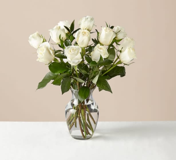 Moonlight White Rose Bouquet - Uplifting, bright, and fit for any phase of life. A farm-fresh selection of a dozen white roses fills a clear glass vase to dazzle everyone you love.  White roses are about 18"H by 13"W.