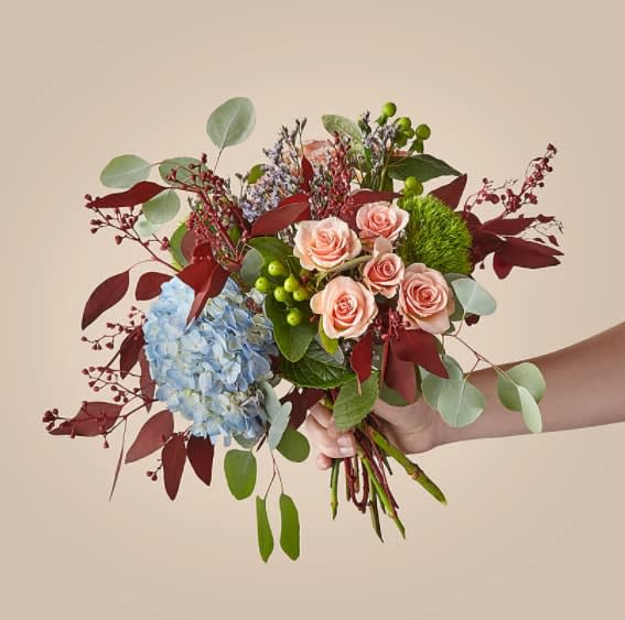 The Ty Bouquet - Fill the season with fresh, vibrant florals. The bouquet's design features hydrangeas, spray roses, trachelium, hypericum berries and eucalyptus.  The Original Bouquet is approximately 19"H by 20"W.